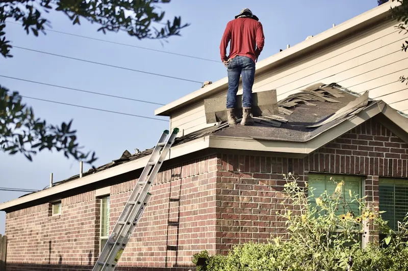 Professional roofer working on a residential roof in Wood Vista